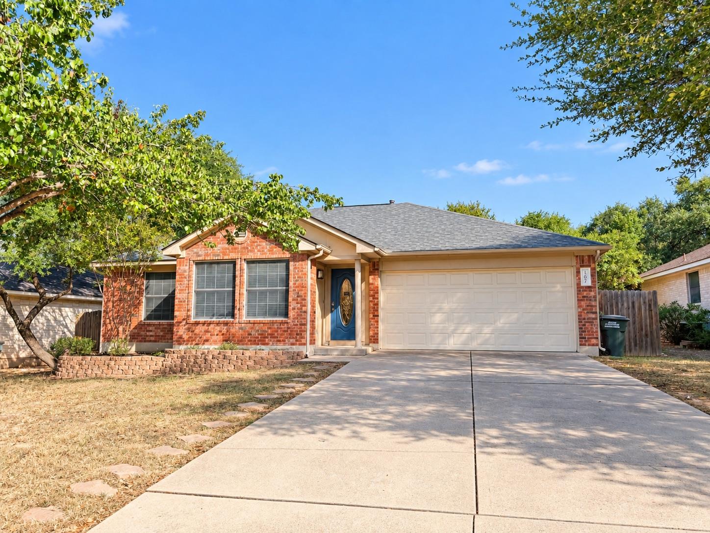 Classic brick exterior and a wide concrete drivew