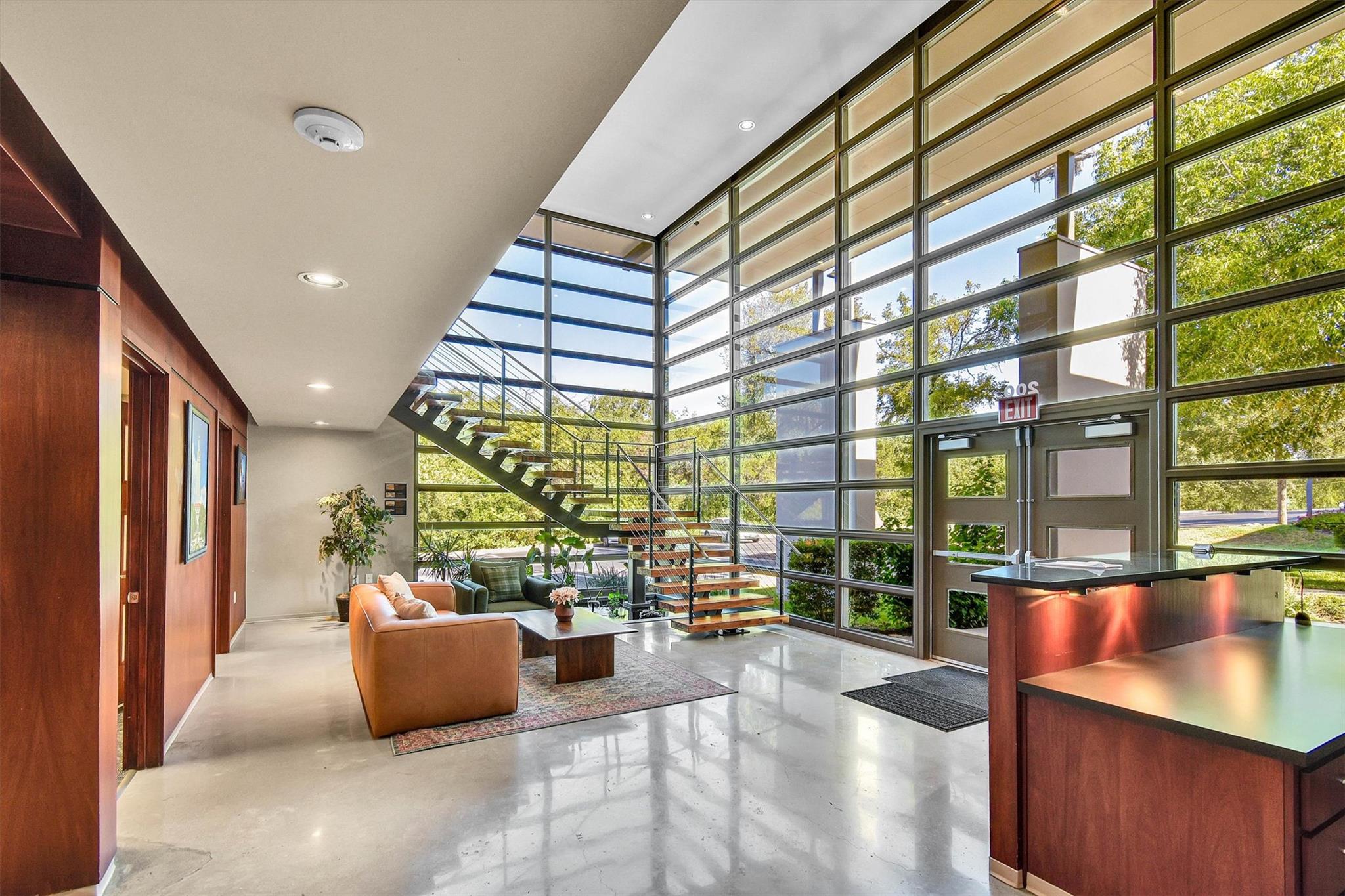 Towering glass walls flood this polished concrete