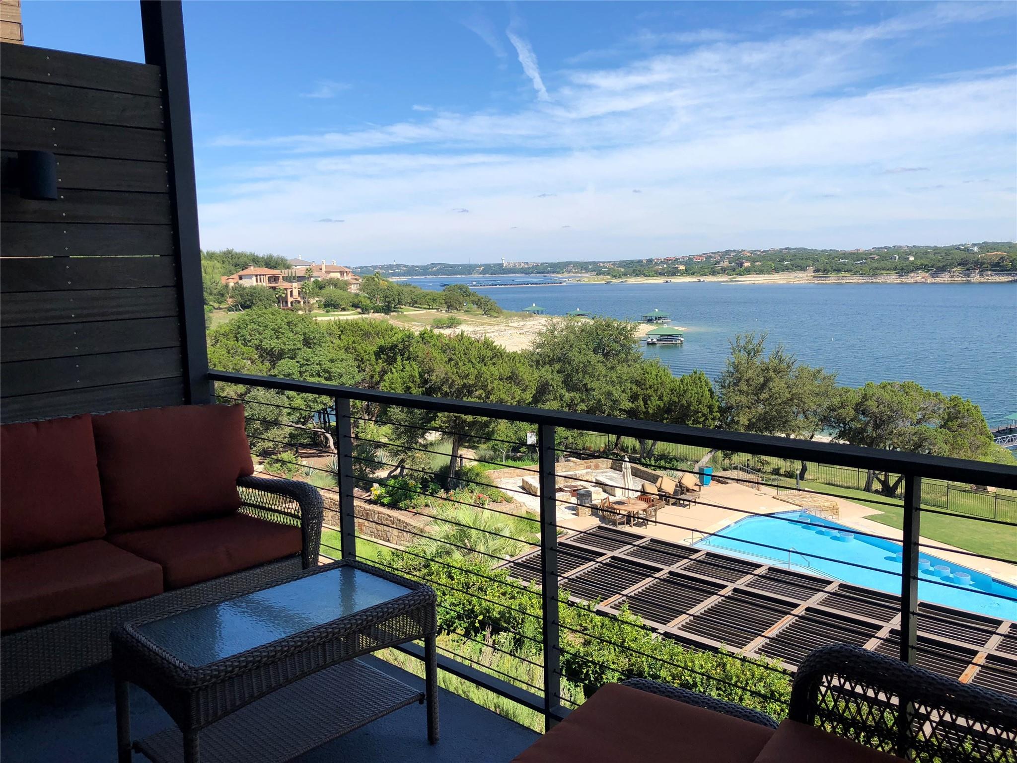 A private balcony looks out over a sparkling pool