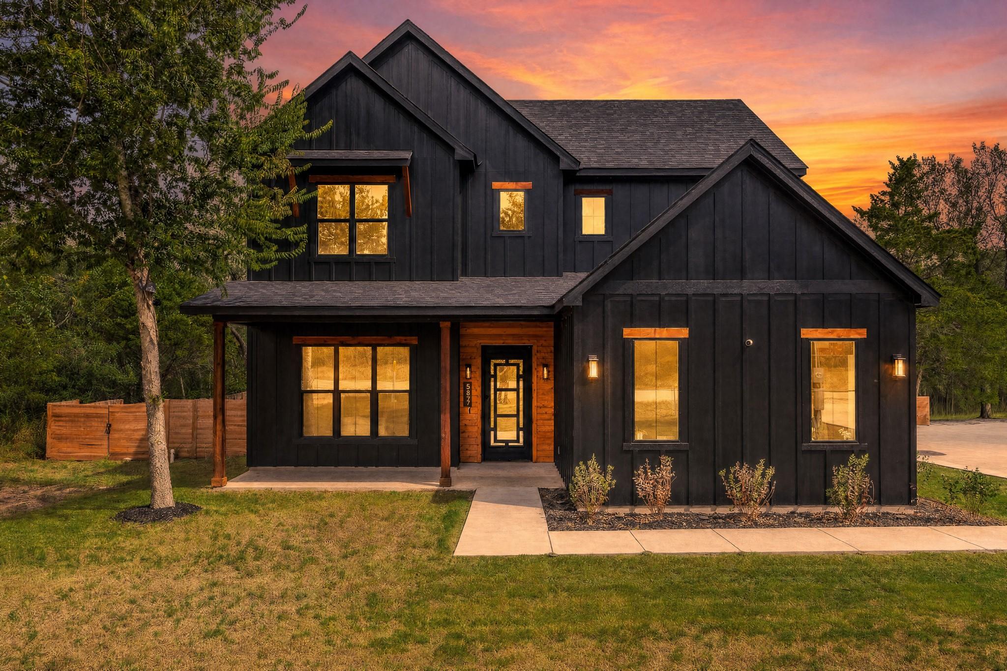 Dark board and batten siding meets warm wood acce
