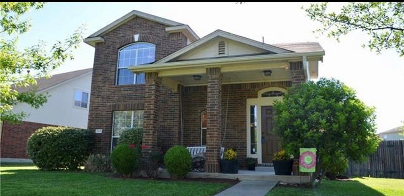 A welcoming front porch with classic brick column