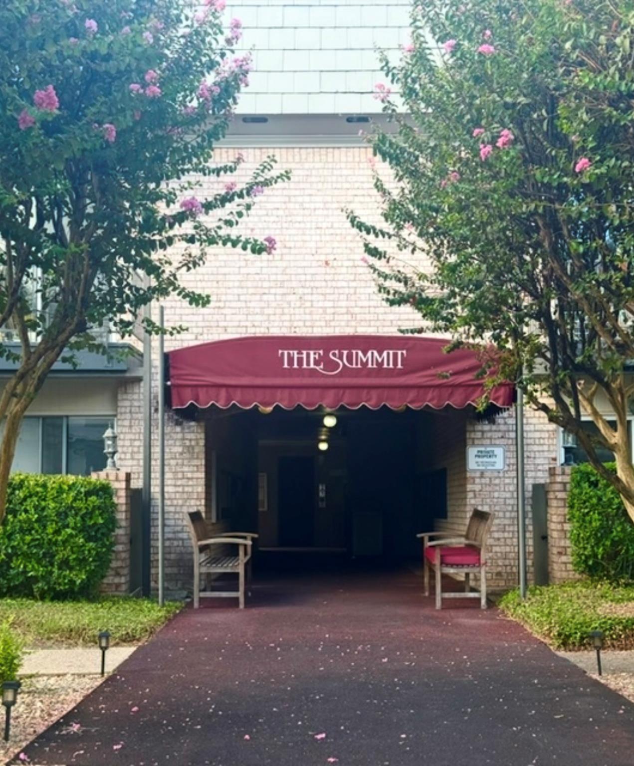 An inviting covered entryway framed by brick maso