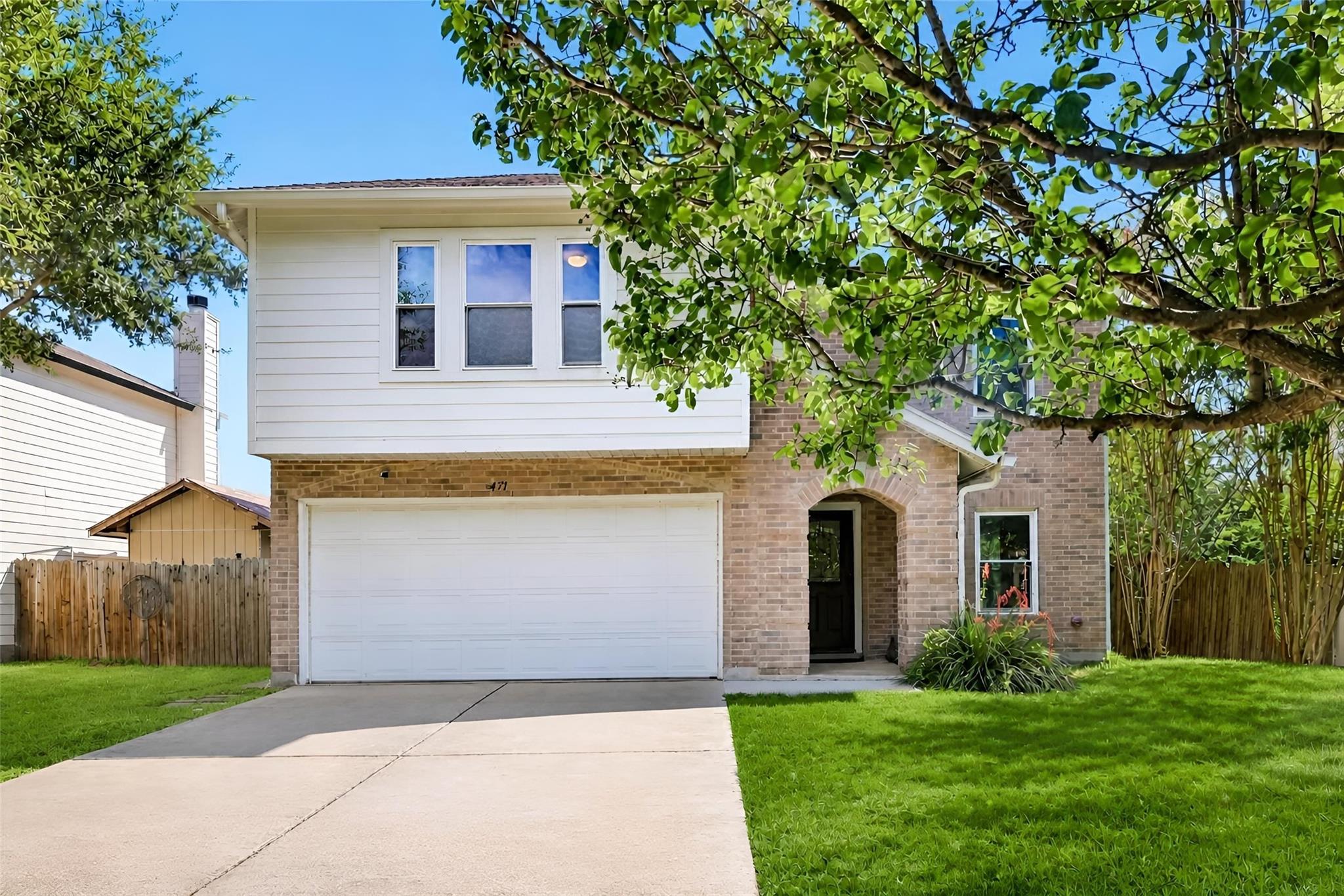 Classic brick and siding accents define this two-