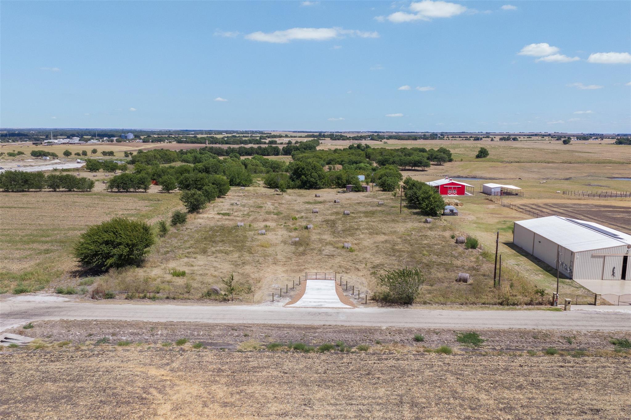 A gated concrete entry leads into a sprawling pas
