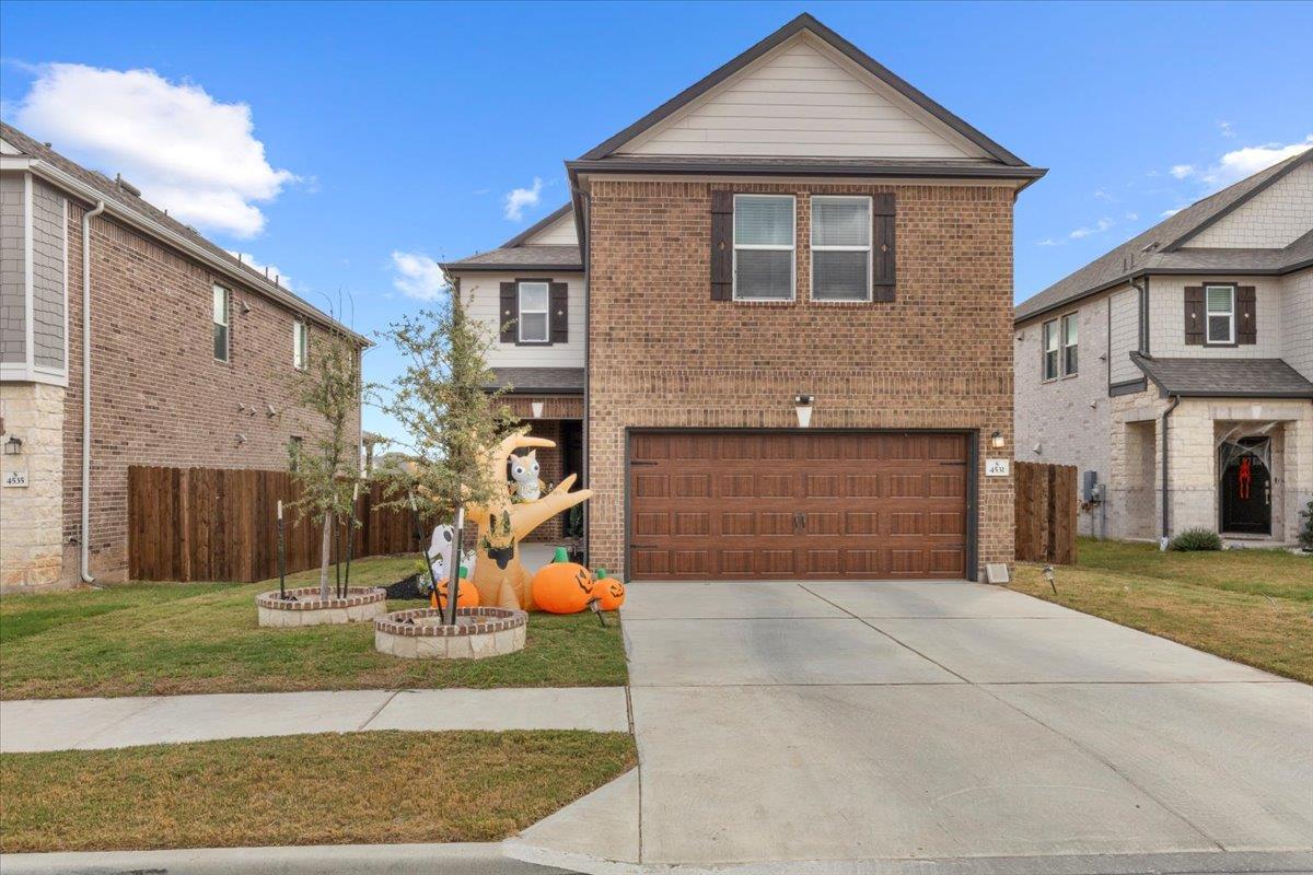 A classic brick exterior and a concrete driveway 