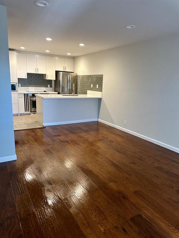Rich hardwood floors transition seamlessly into a