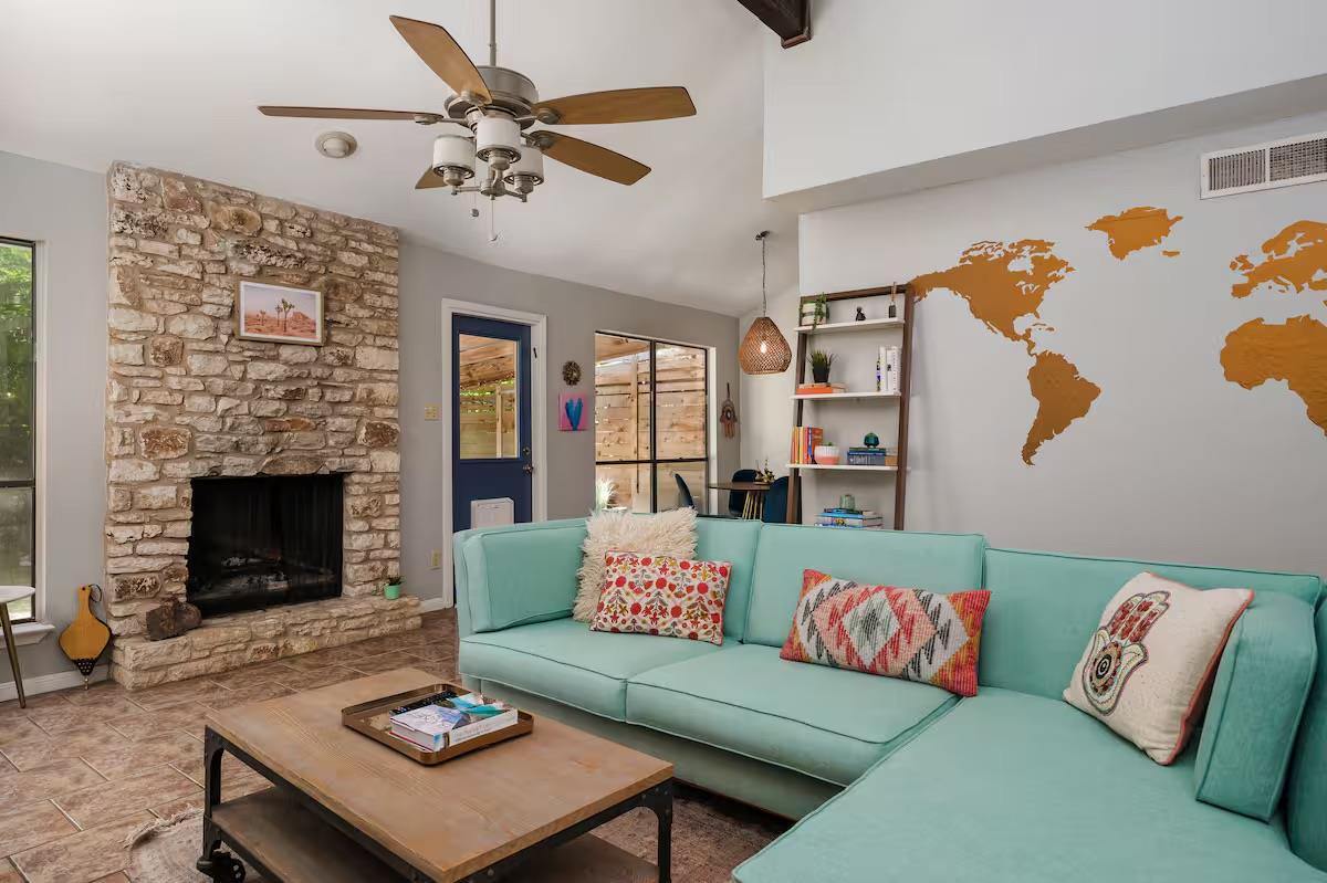 A floor-to-ceiling stone fireplace serves as the 