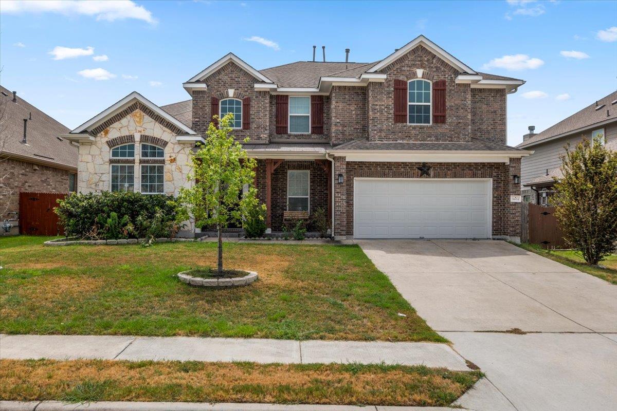 A classic brick exterior and a concrete driveway 