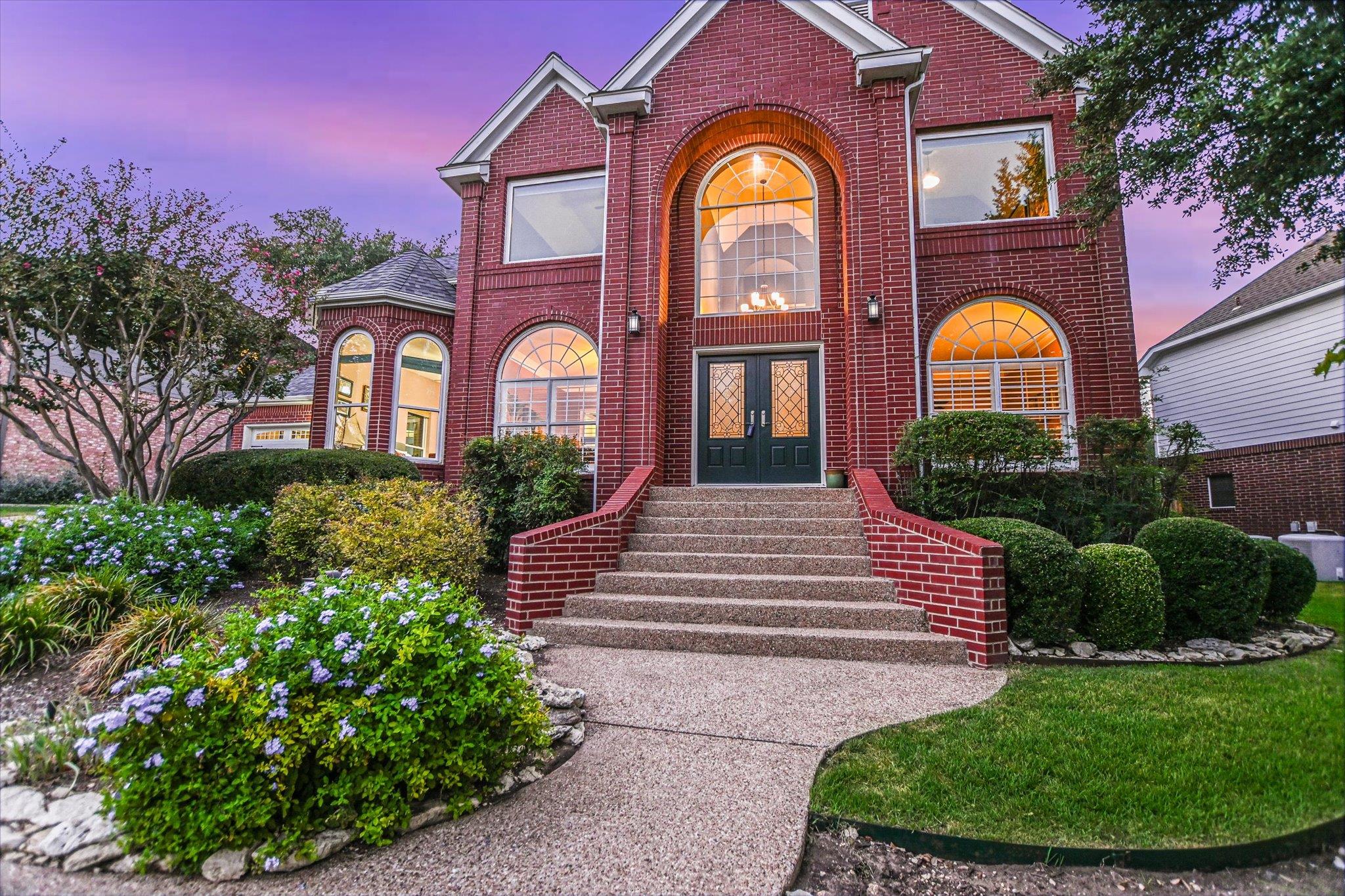 A classic brick exterior and a grand entryway cre