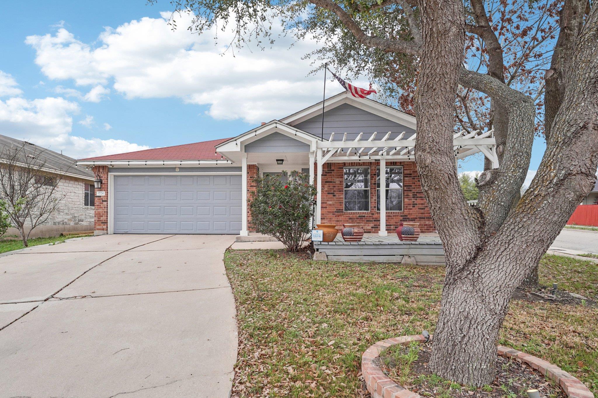 View of front of home with concrete driveway, an 
