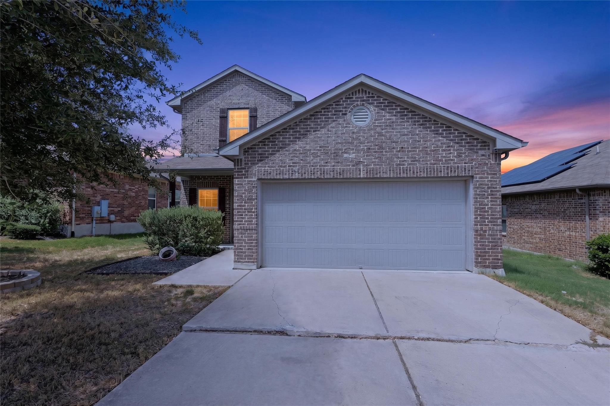 A classic brick exterior and a concrete driveway 