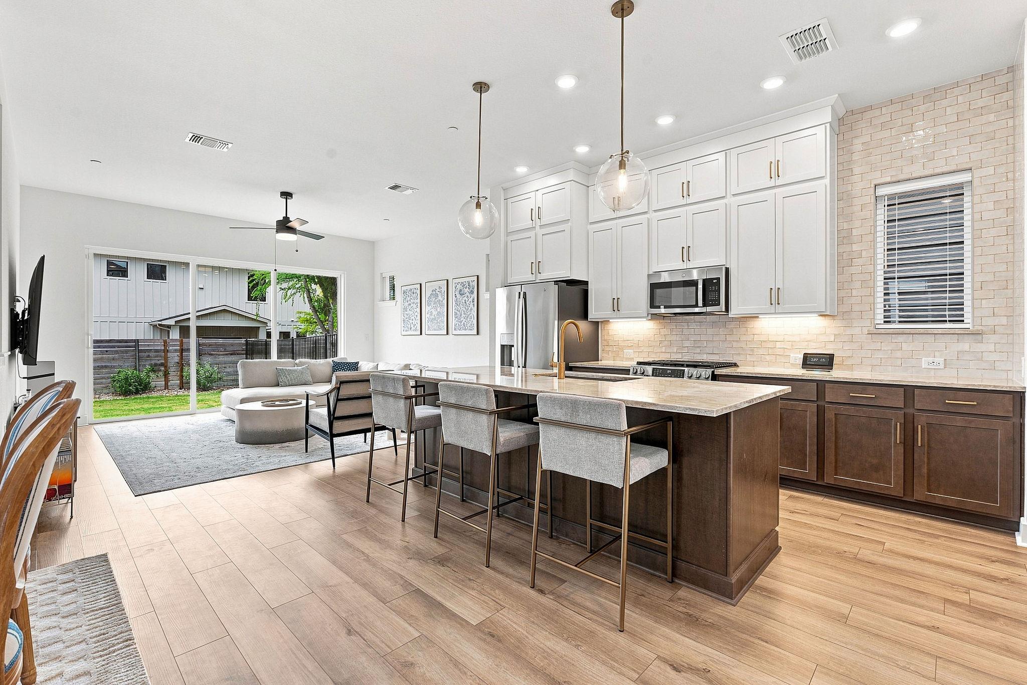 An open-concept layout connects the kitchen to th