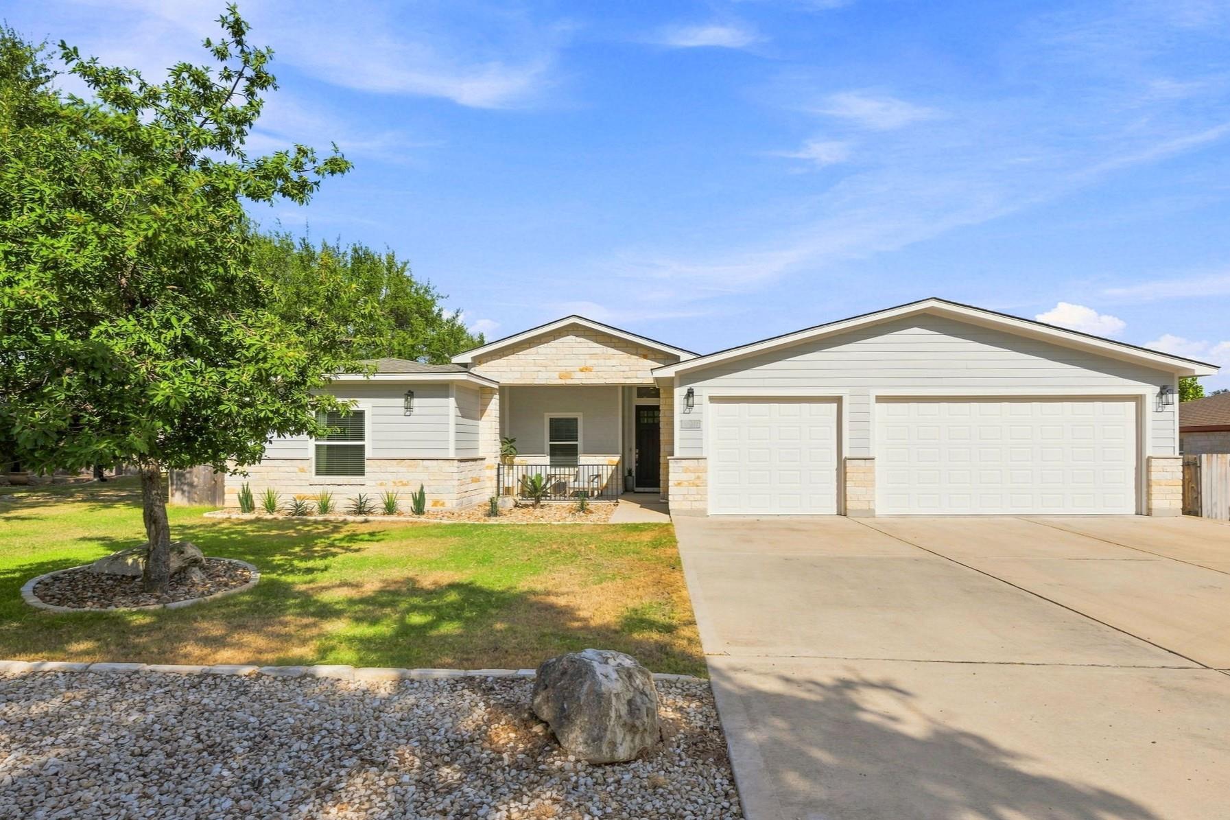 Crisp stone accents and a wide driveway define th