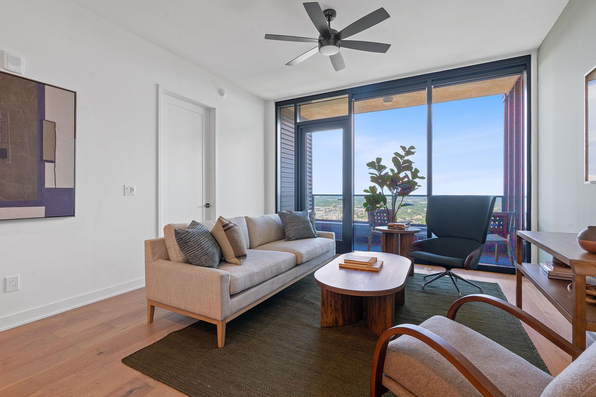 An airy living room with a large glass door leads