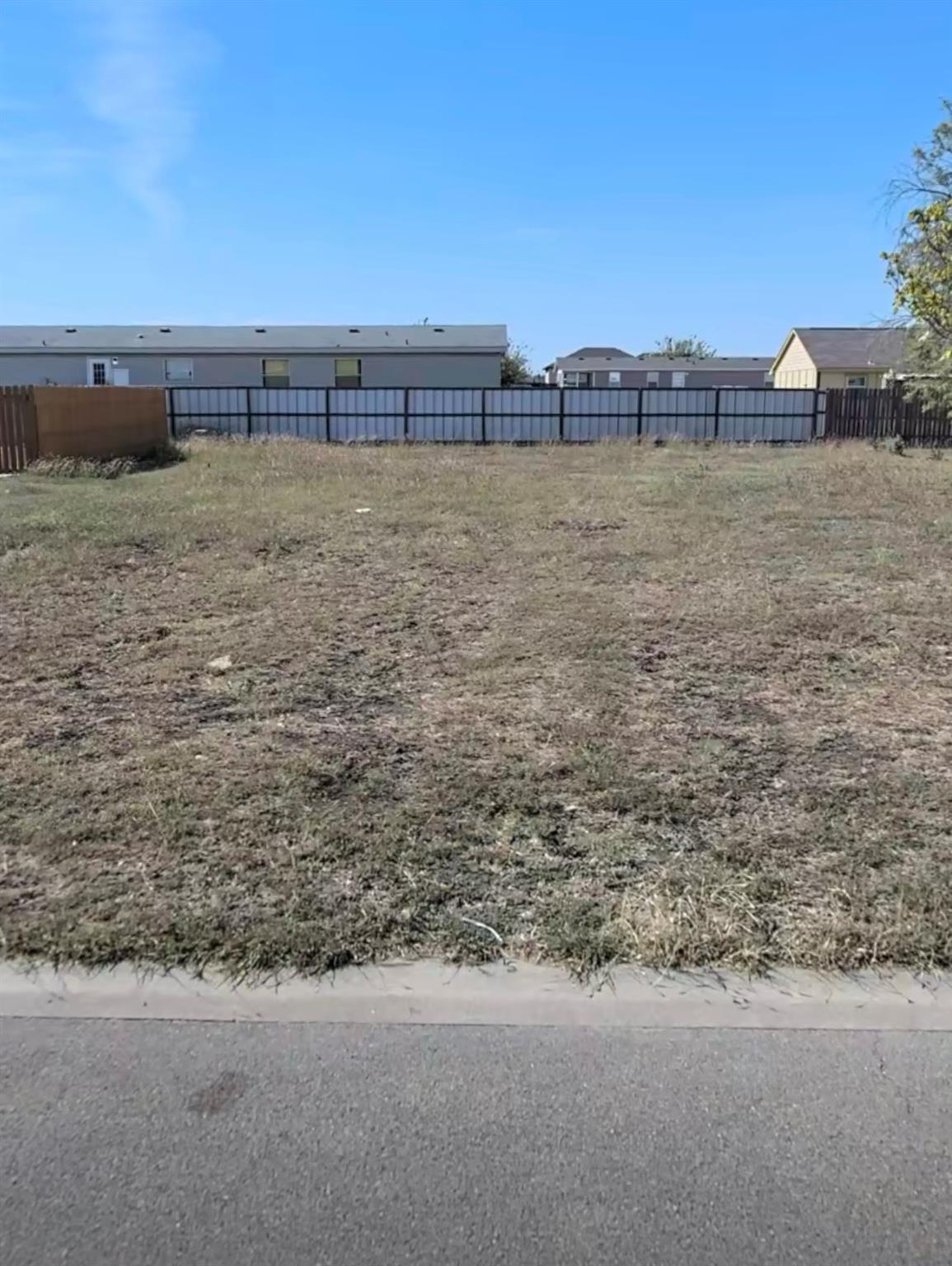 An open building lot stands ready for development