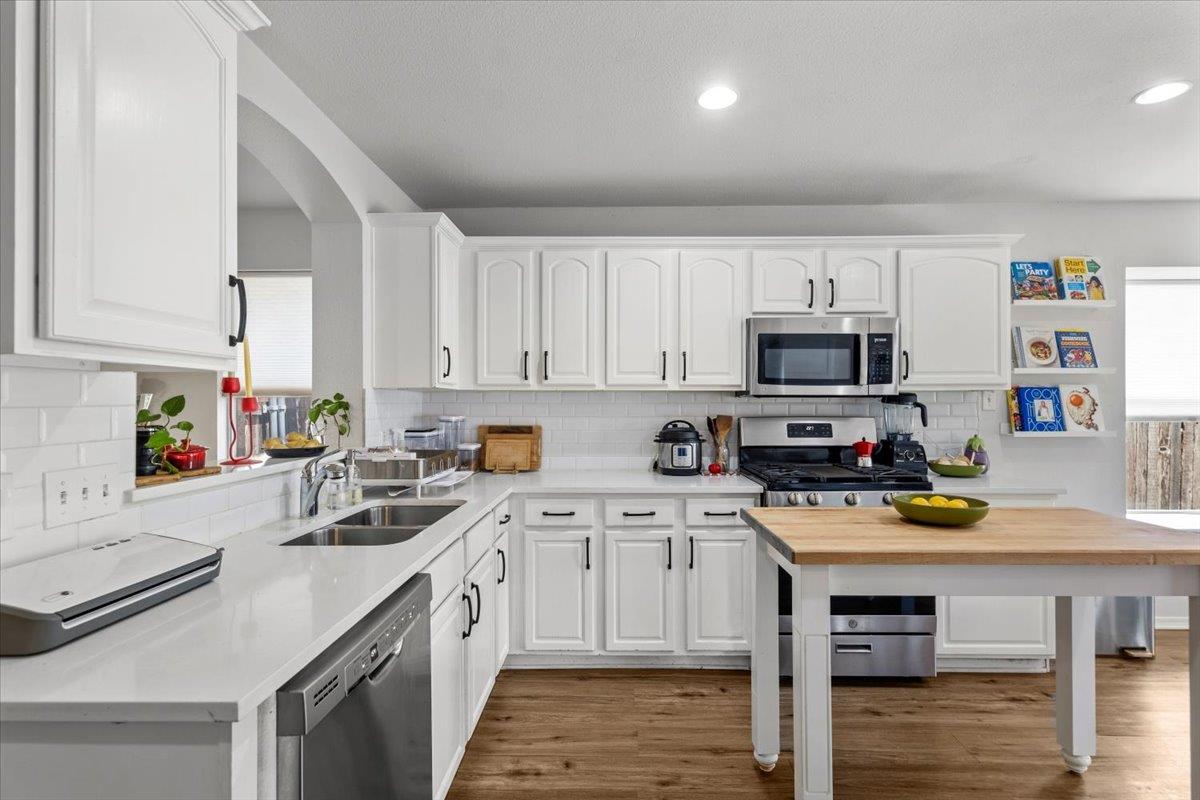 Crisp cabinetry and warm wood flooring define thi
