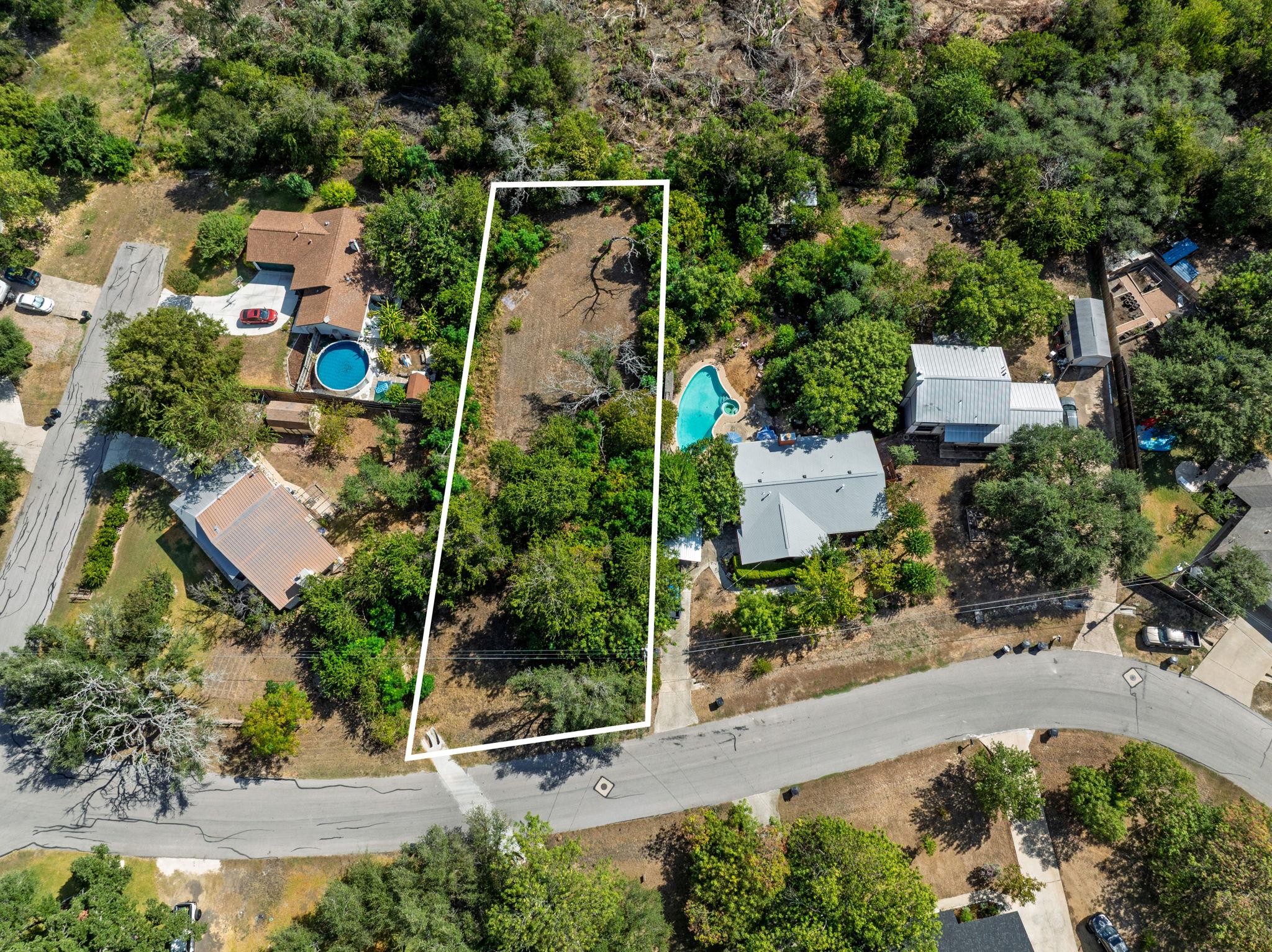 Mature trees frame this generous building lot in 