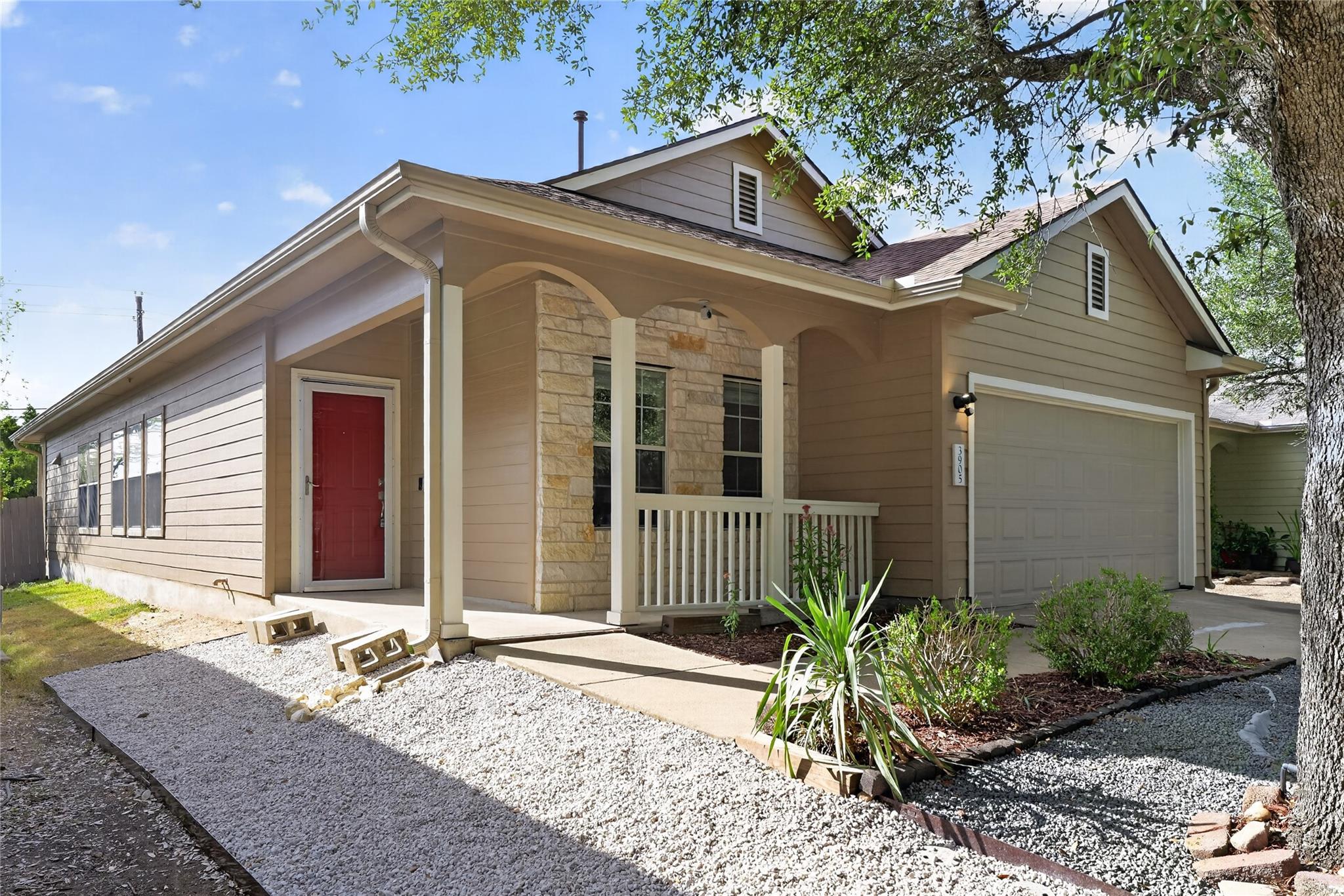 A welcoming front porch and stone accents highlig