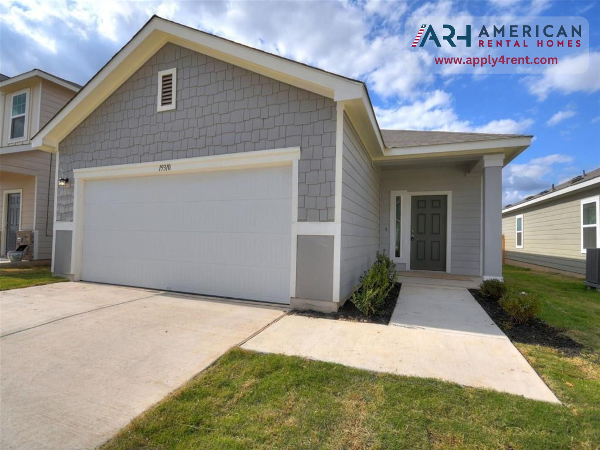 View of front of home with a garage, driveway, an