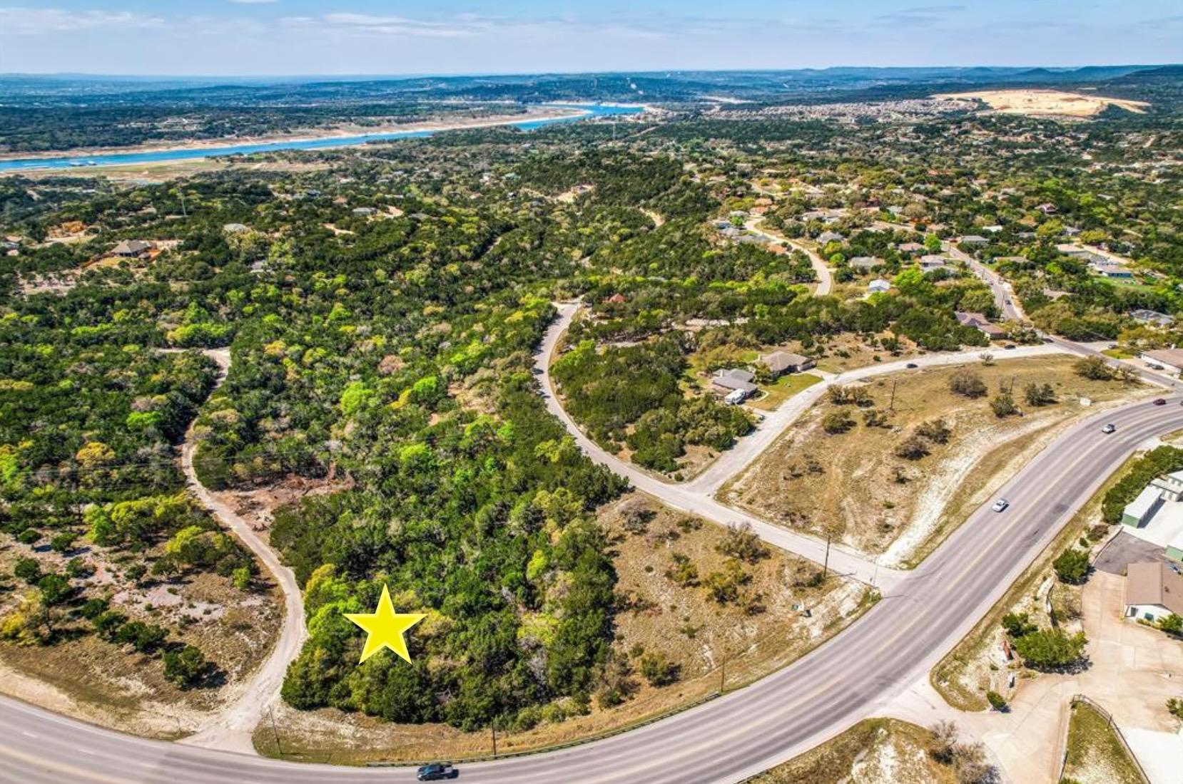 A winding road borders this wooded lot, offering 