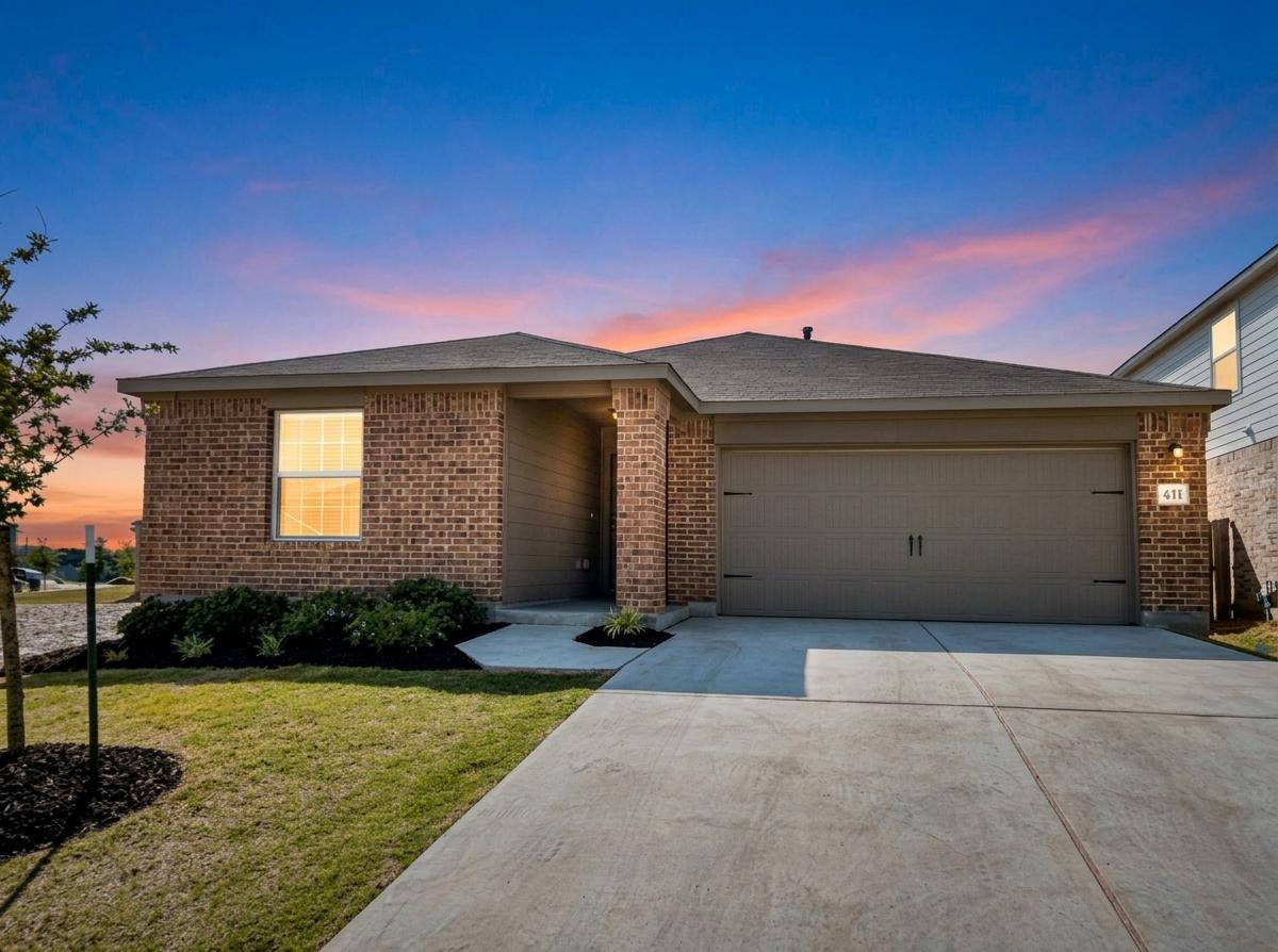 Classic brick accents and a spacious concrete dri