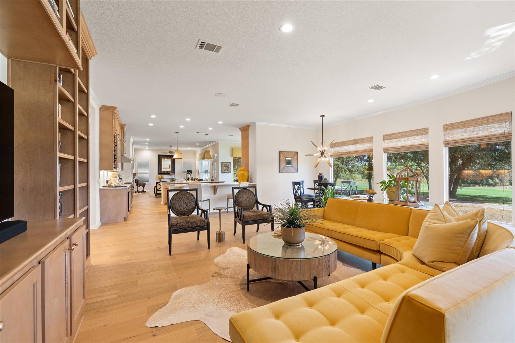 Warm hardwood flooring and built-in shelving anch