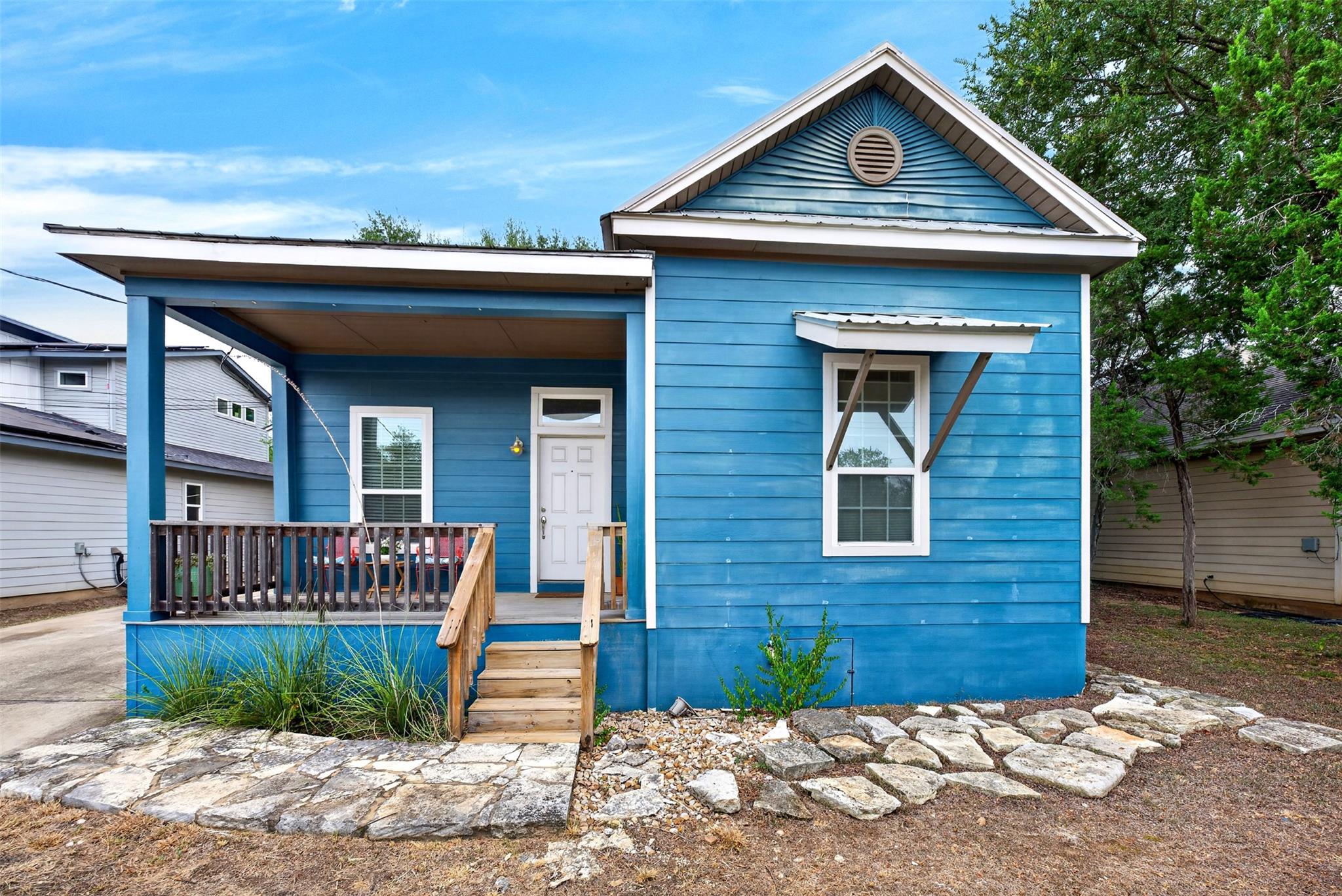 A welcoming front porch with wooden steps creates