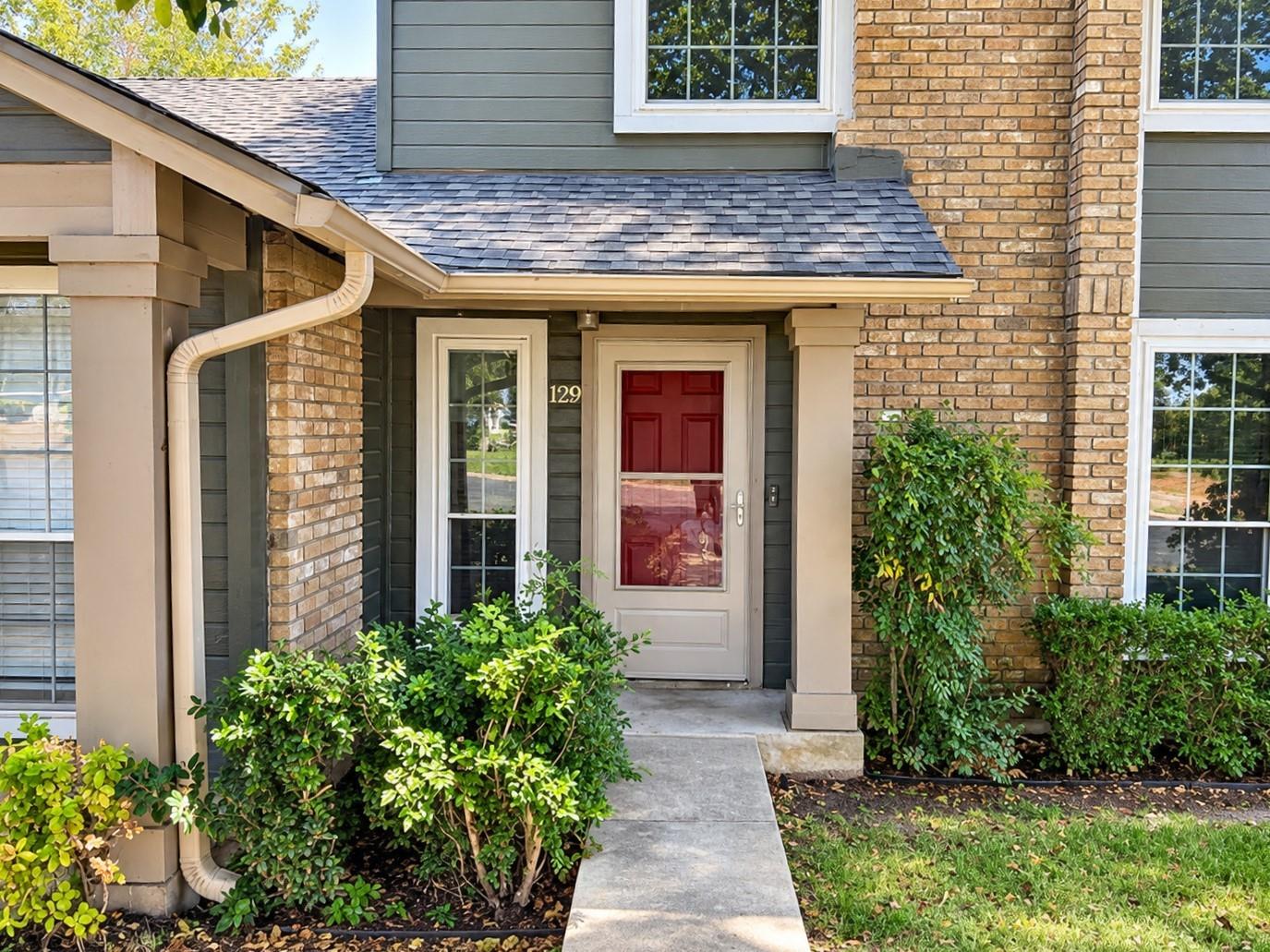 An inviting concrete walkway leads to the classic