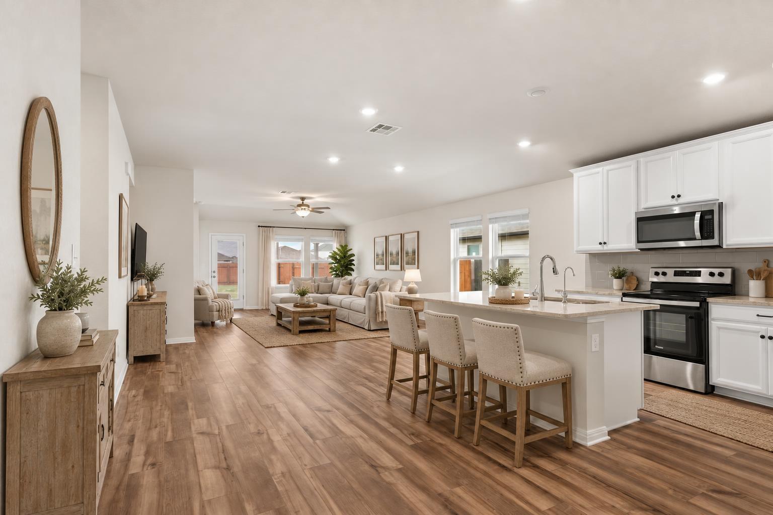 Warm wood-style floors connect a modern kitchen t
