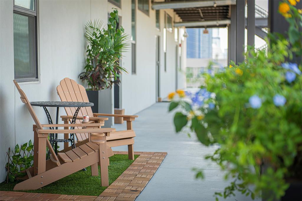 A long, covered walkway with concrete flooring pr