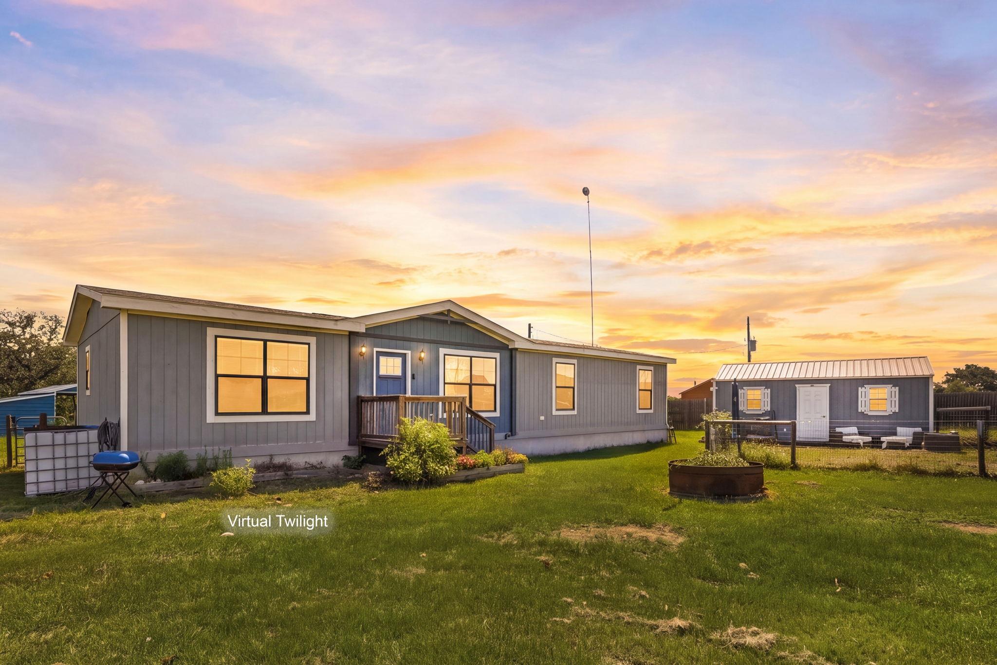 An expansive green lawn surrounds this charming h