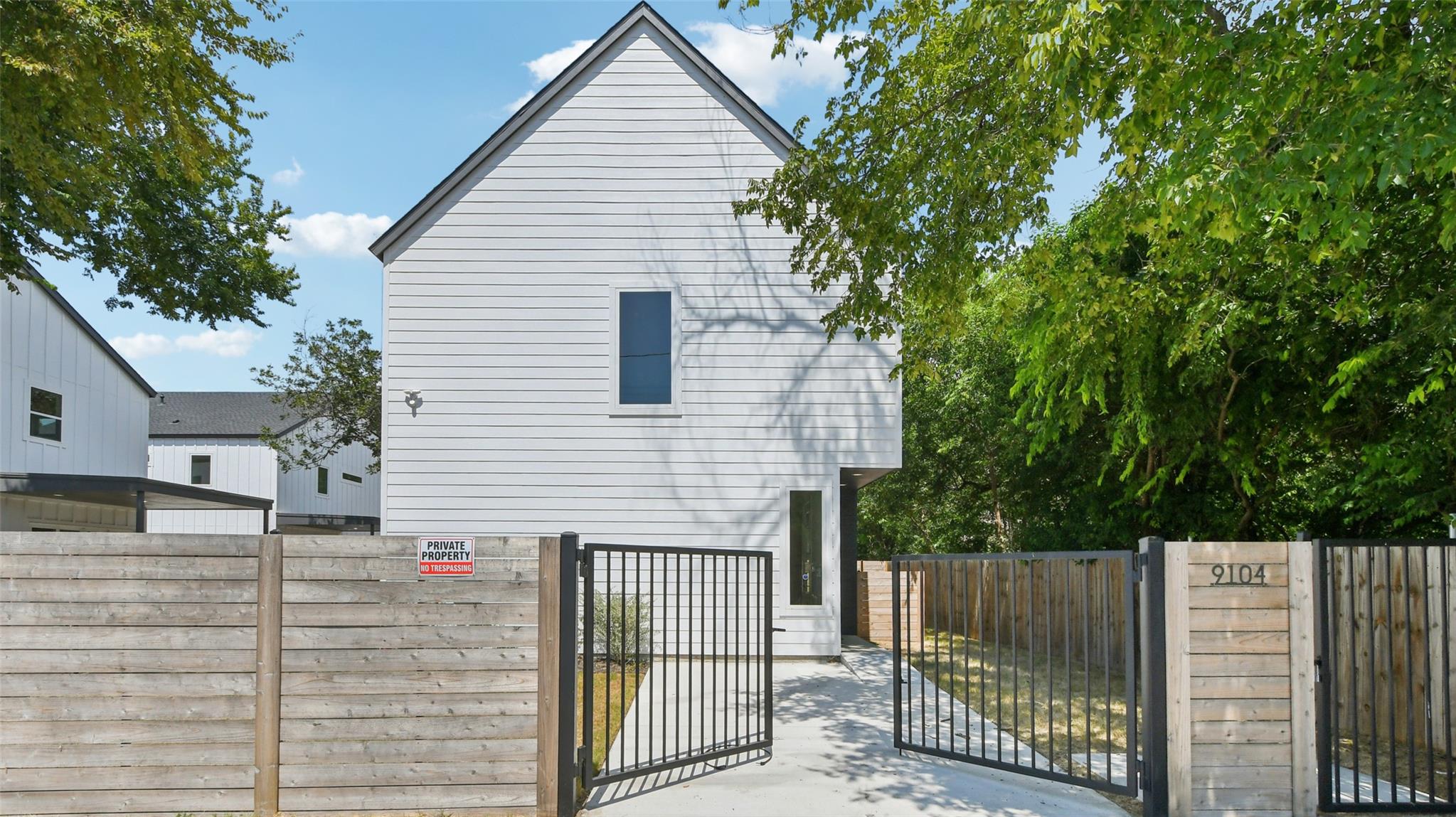 Crisp horizontal siding and a steep roofline defi