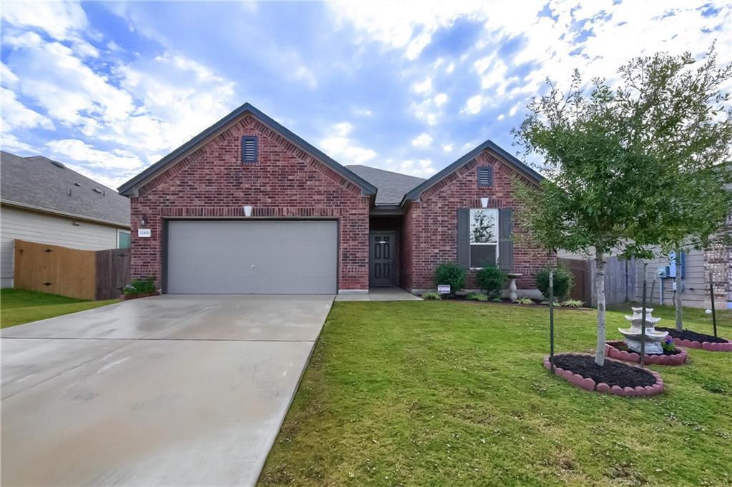 Classic brick exterior showcases a two-car garage