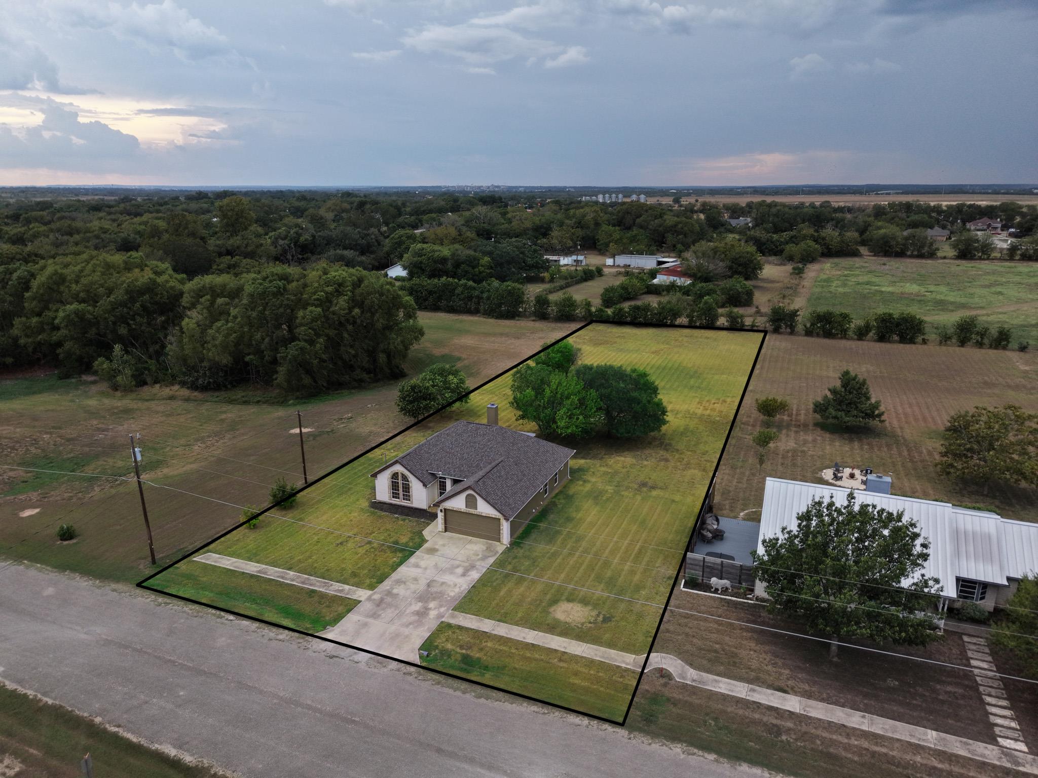 An aerial perspective showcases a neat suburban p