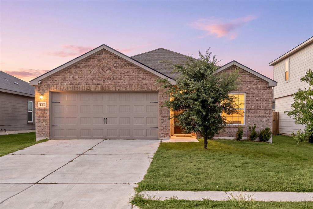 A classic brick exterior and concrete driveway de