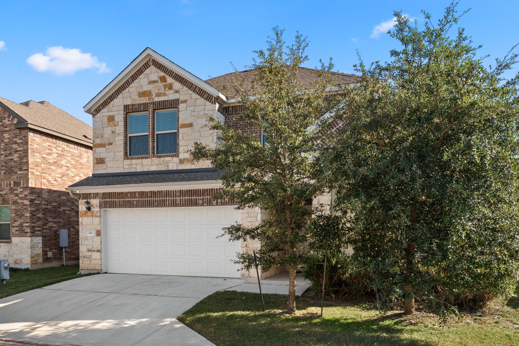 Limestone and brick accents frame this elegant tw