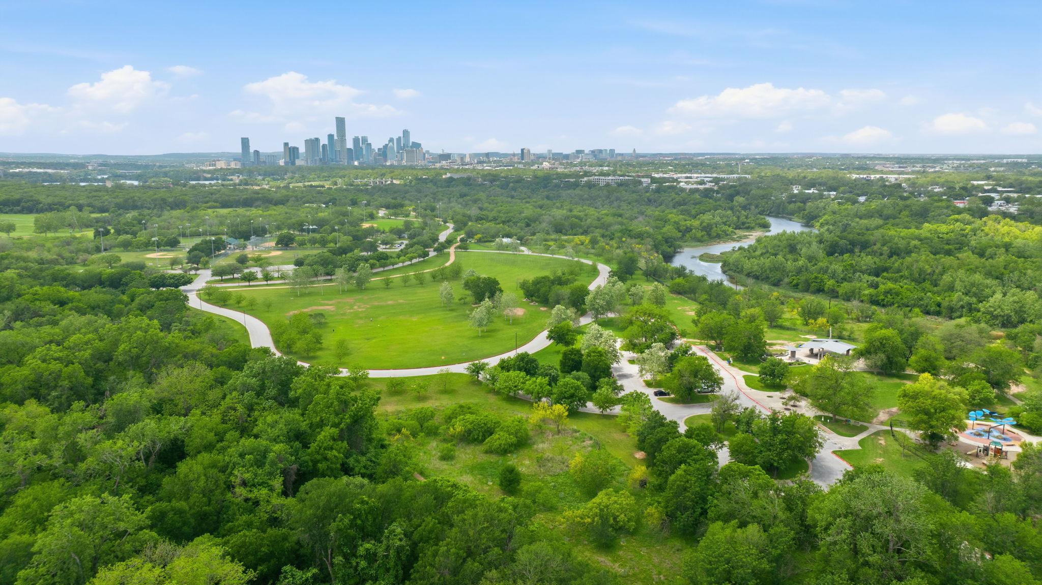 Expansive green spaces and mature trees surround 