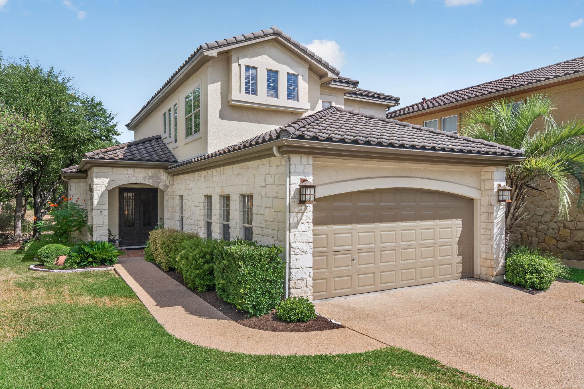 Elegant stone accents and tile roofing highlight 