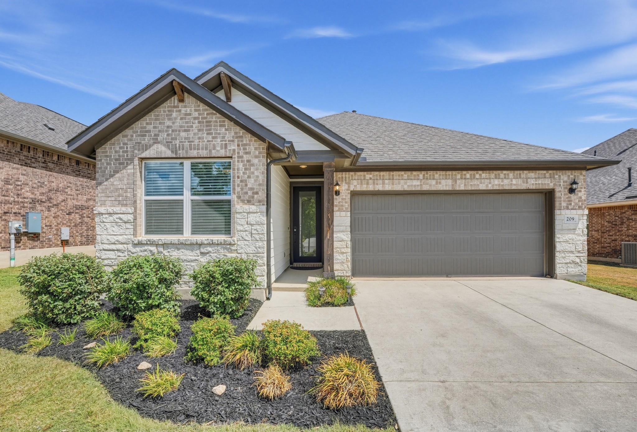 Textured stone and brick accents complement the g