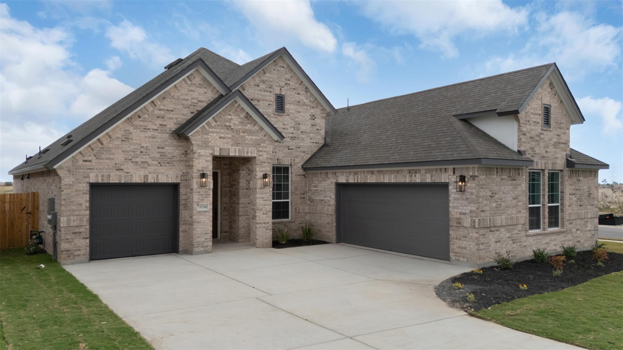 Multi-gable rooflines and textured brick define t