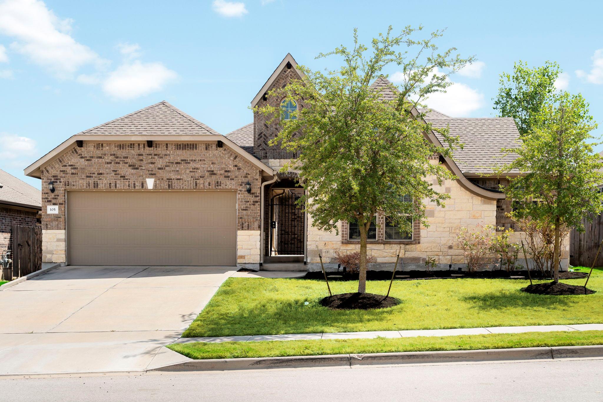 Textured brick and stone masonry complement the a