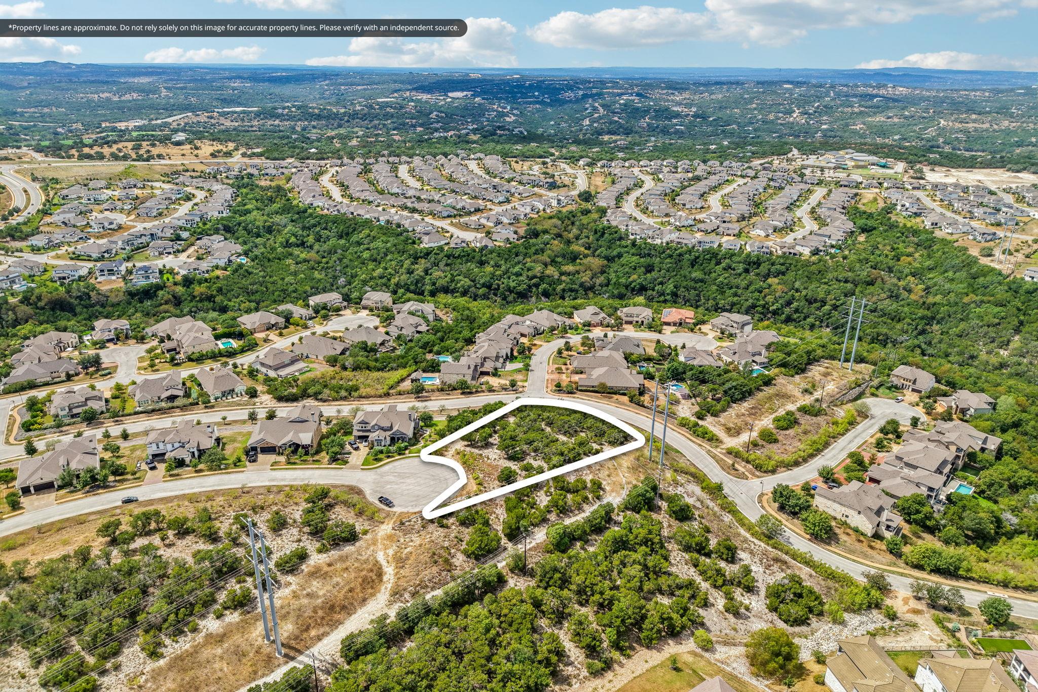 An aerial view highlights the buildable site surr