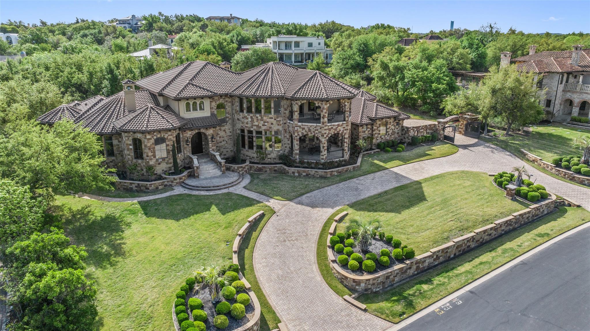 An imposing stone estate stands framed by meticul