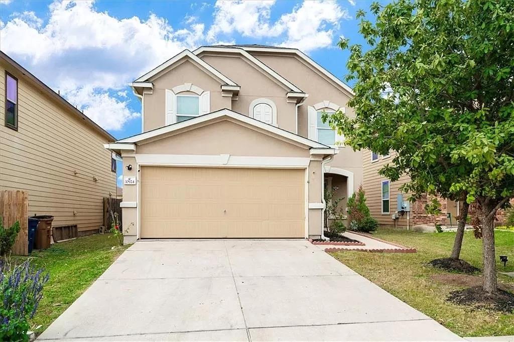 A spacious driveway leads to this multi-level hom