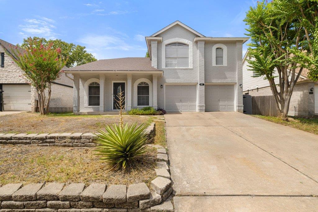 A spacious driveway leads directly to this classi
