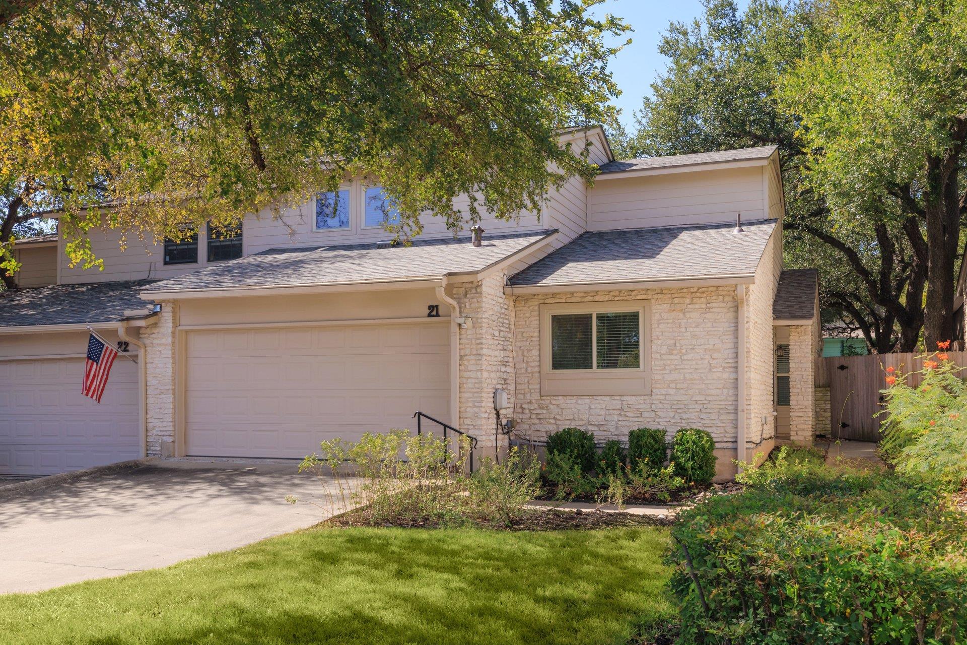 Mature trees shade a classic multi-level exterior