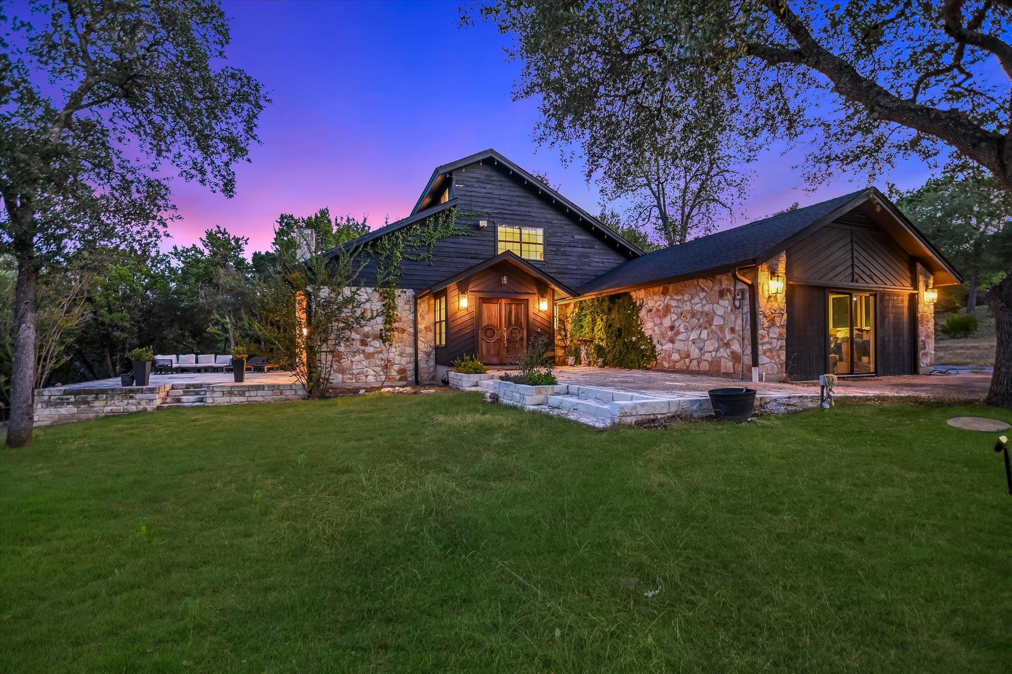 Natural stone and dark wood siding define this st