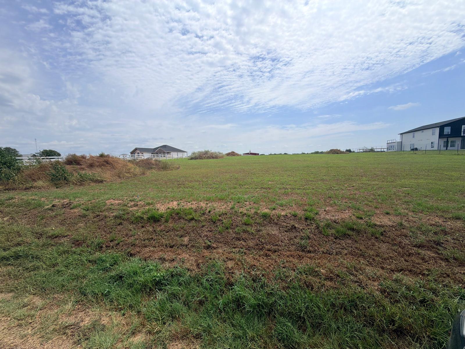 A spacious grassy pasture offers building potenti