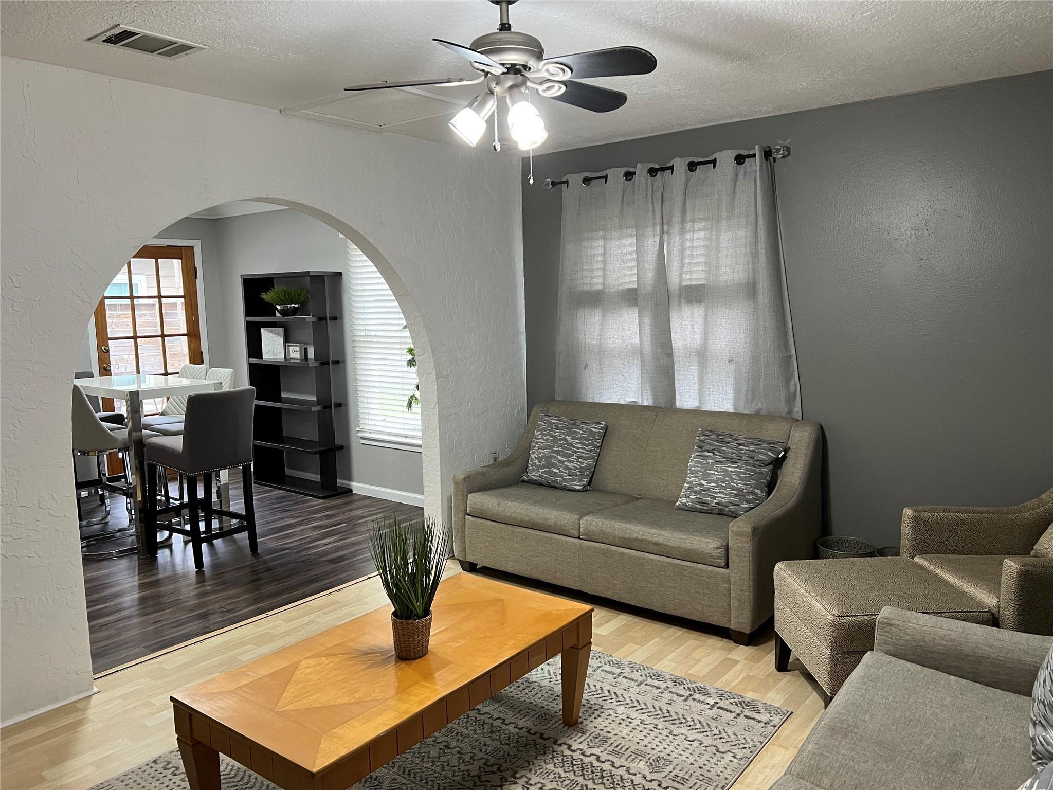 An arched doorway connects the inviting living sp