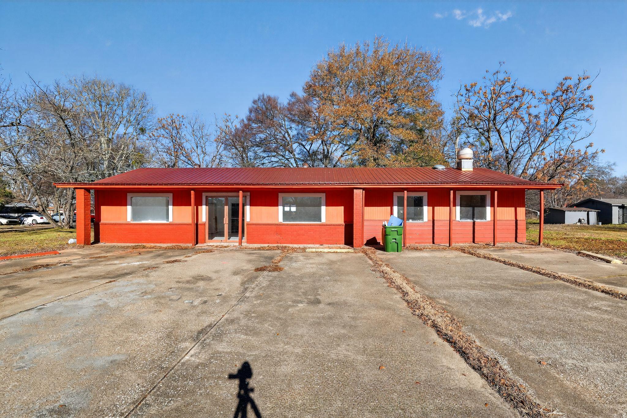 View of front of property with a chimney and a me